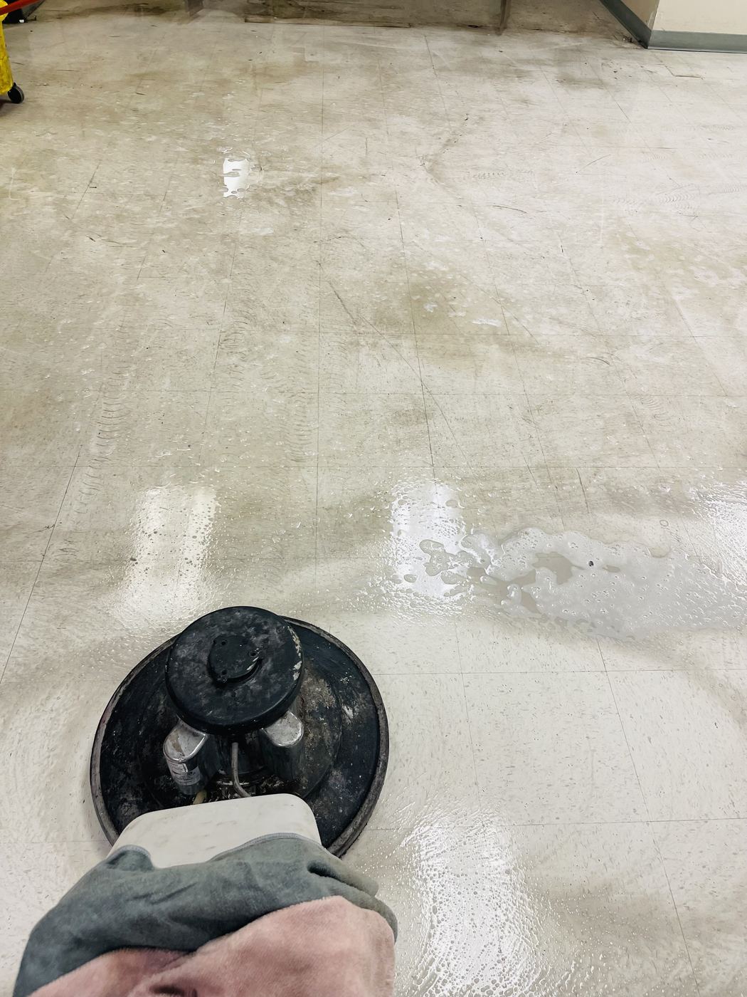 Worn commercial tile floor before stripping and waxing